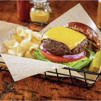 hamburger and chips in basket with basket liner