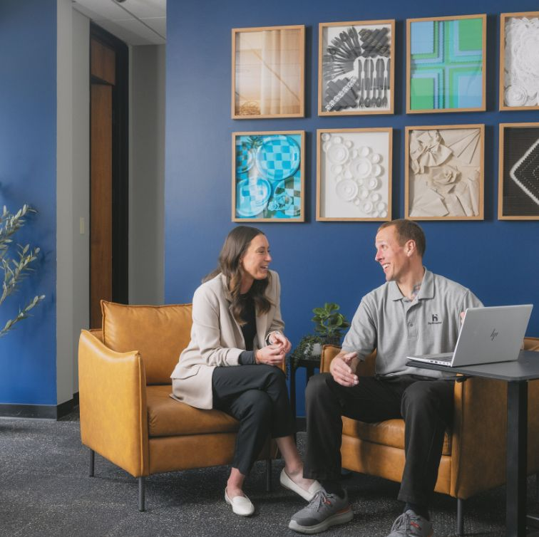 two people sitting in office talking