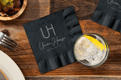 Custom print logo on a black cocktail napkin