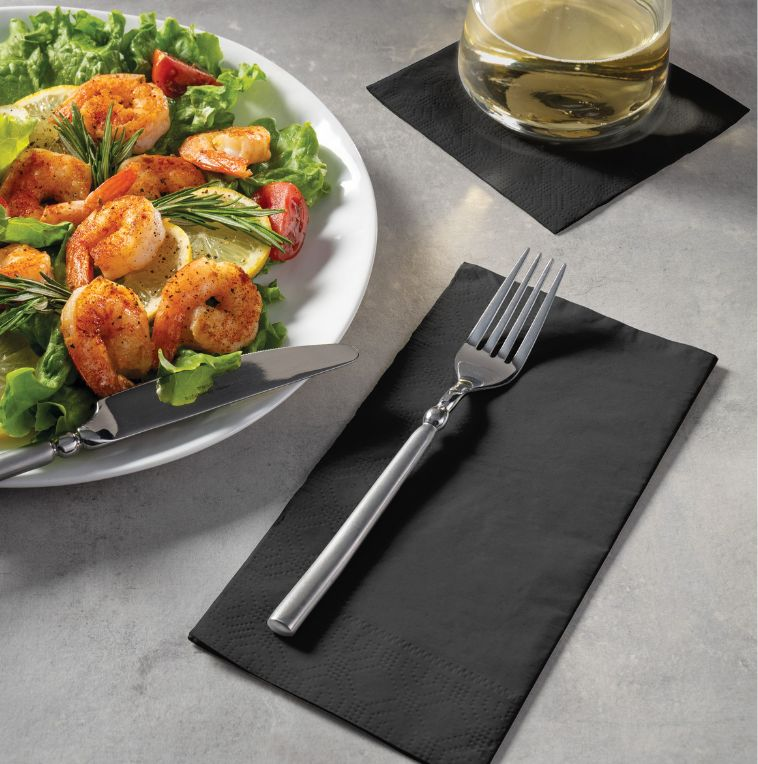 black dinner napkin with fork, black cocktail napkin with wine on top, next to a salad plate